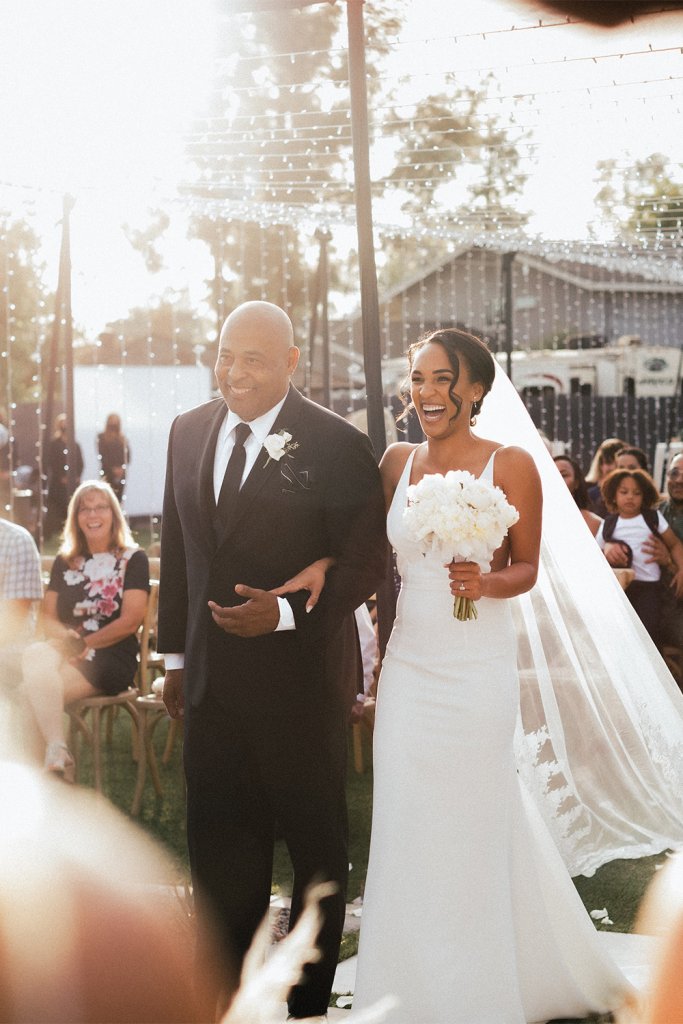 Man walking bride down the aisle - Have a family member officiate your small wedding ceremony